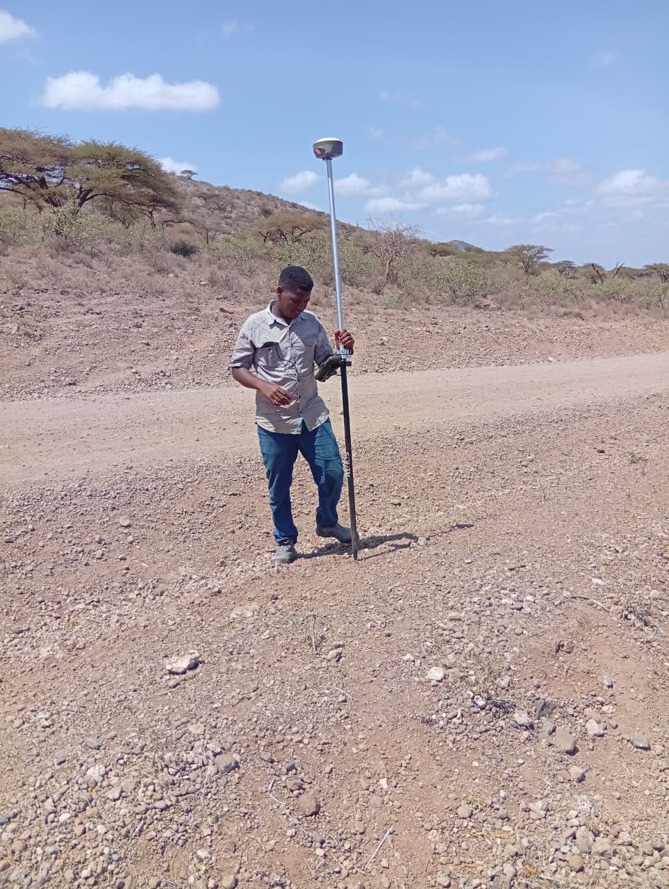 Joseph Musyimi with surveying equipment